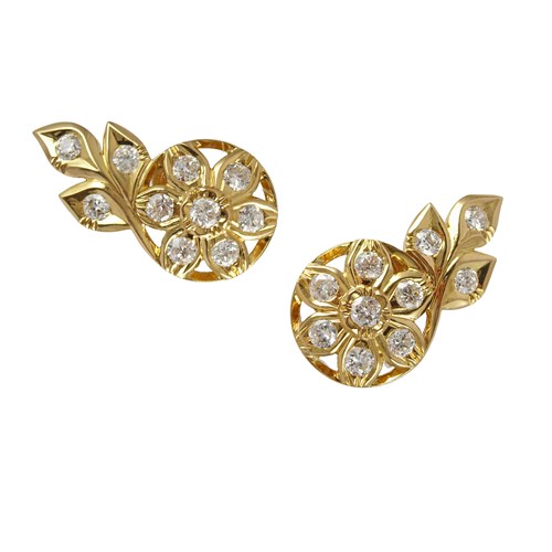 Pair of diamond and yellow gold flowerhead and triple leaf cluster earrings by Cartier, Paris,